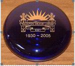 Blue glass paperweight with lodge emblem