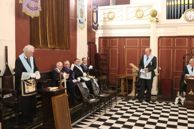 Image of lodge members and visitors in the temple.