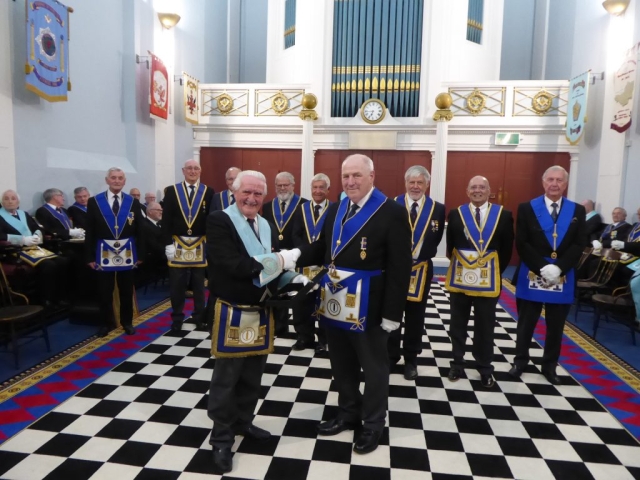 Queens College Lodge members presenting the travelling towel.